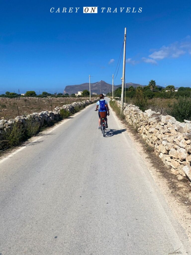 Biking Favignana Island, the peak with Santa Catarina is in the distance