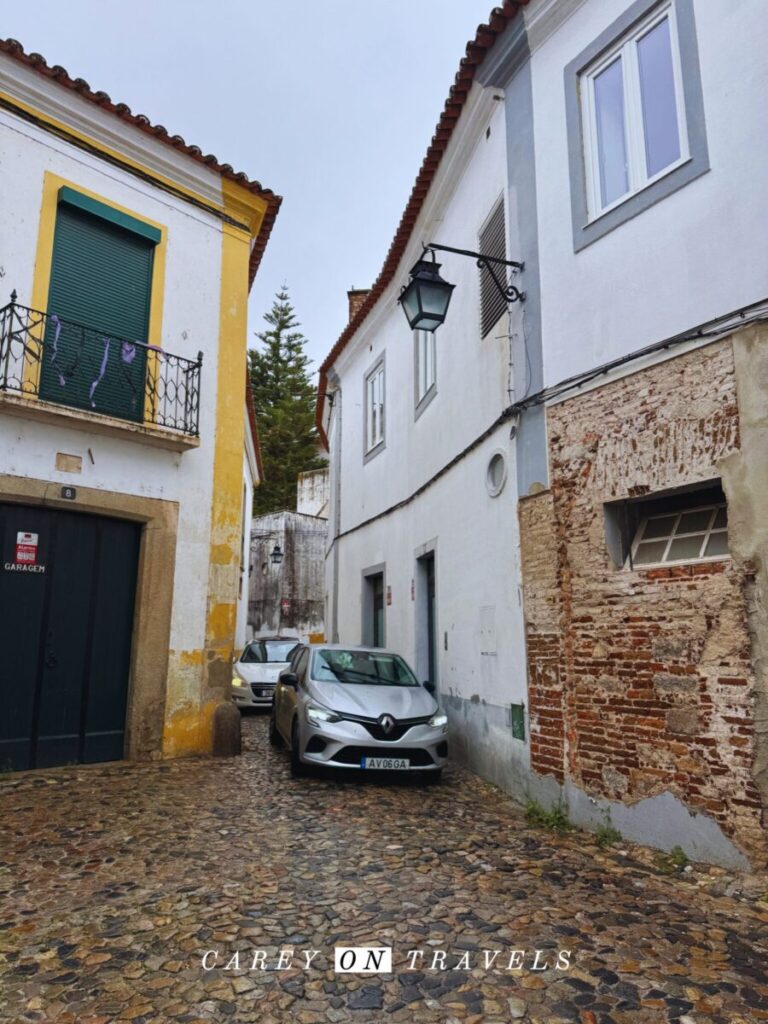 Cars navigating the narrow streets of Evora